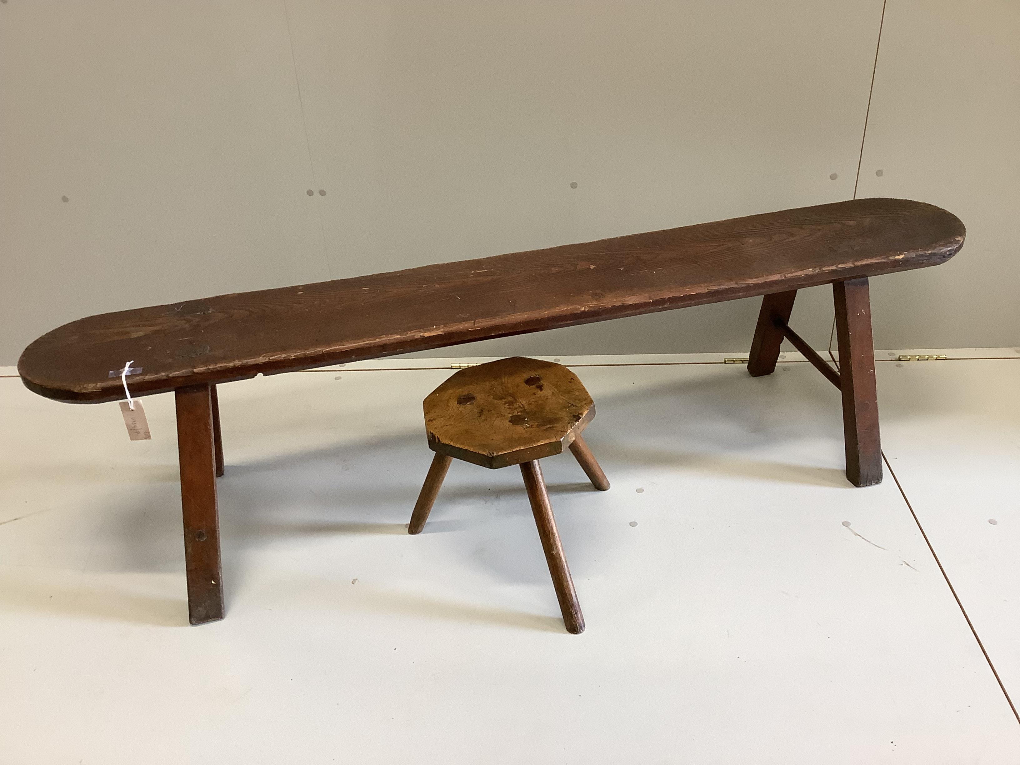 A 19th century pine and fruitwood bench and an elm hexagonal stool, bench length 172cm, height 46cm.